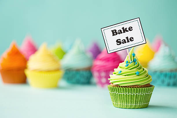 cupcake with bake sale sign